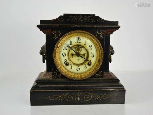 A Victorian slate mantle clock, with lion head handles and a...