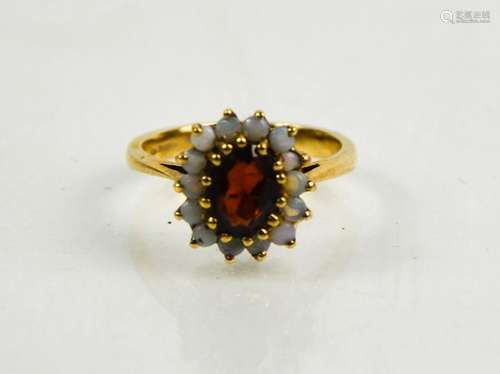 A 9ct gold, garnet and opal ring, size N, 3.56g