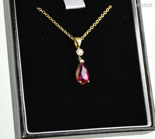 A yellow gold, rubellite and diamond pendant and chain, the ...