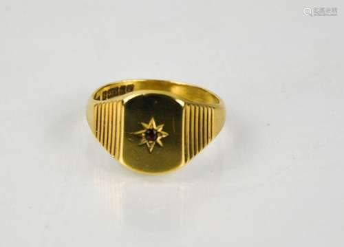 A 9ct gold gentleman's signet ring, set with a garnet to the...