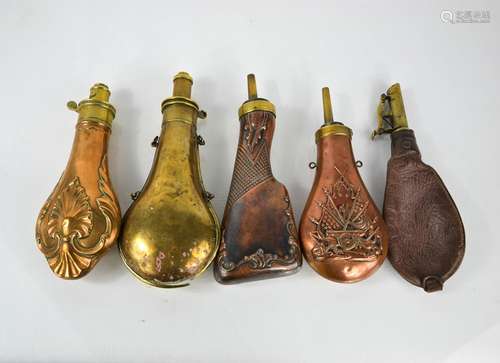 A group of five 19th century powder flasks, two in copper wi...