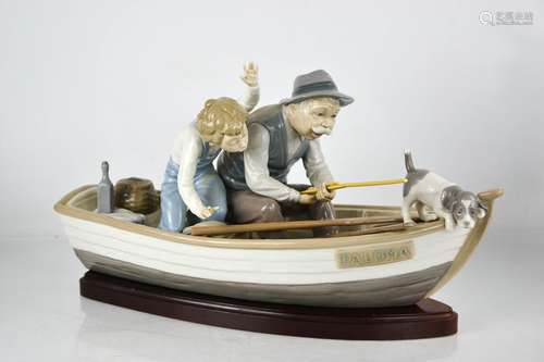 A Lladro porcelain group titled Fishing with Gramps, on a bo...