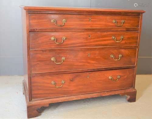 A Georgian mahogany chest of drawers raised on bracket feet,...