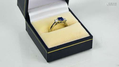 A platinum, blue sapphire and diamond three stone ring, size...