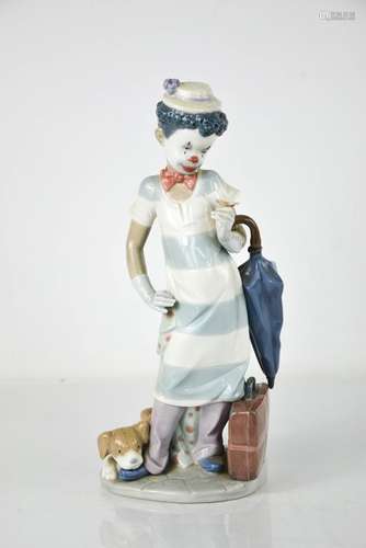 A Lladro clown, holding an umbrella with puppy at his feet, ...