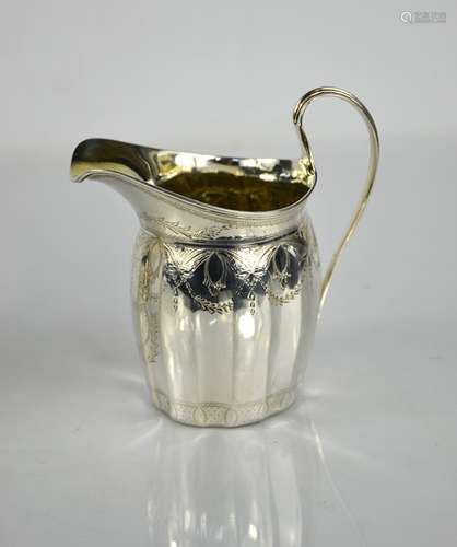 A silver jug, engraved with decoration, hallmarked London 17...