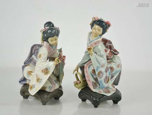 Two Lladro porcelain geisha girls picking flowers.