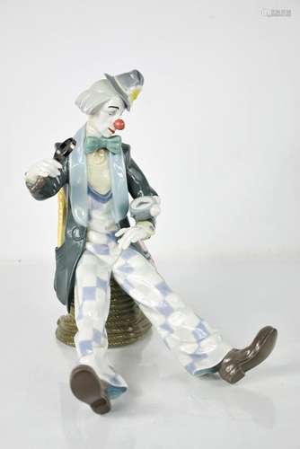 A Lladro porcelain clown, with alarm clock and magnifying gl...