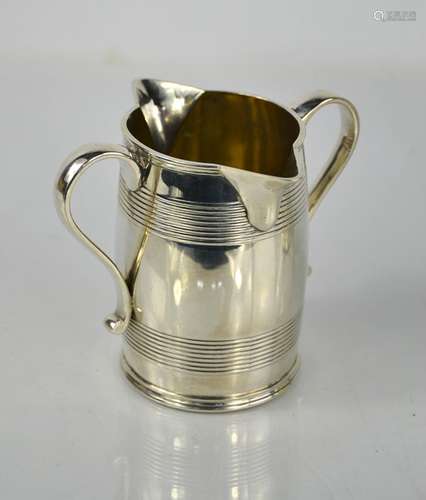 A Victorian silver double lip jug by FB Thomas, London 1895,...