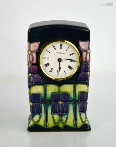 A Moorcroft pottery clock, inspired by the design for Libert...