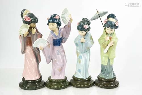 A set of four Lladro porcelain geisha girls, one holding a p...