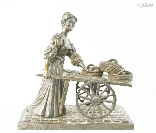 A bronze style model of a female seller with a cart. 33cms t...