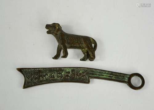 A small bronze tiger, and a Chinese bronze amulet with calli...