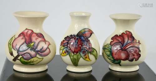 Three Moorcroft vases, two in the Magnolia pattern, one limi...