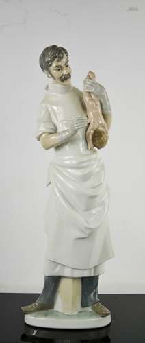 A Lladro porcelain Obstetrician with Newborn Baby, numbered ...