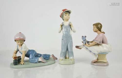 Three Lladro porcelain figurines: Boy from Madrid, All Aboar...