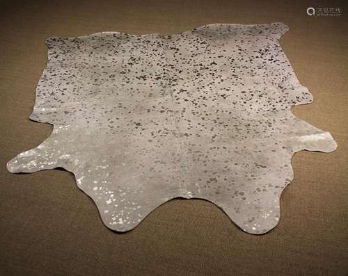 A Decorative Brazilian White Cow Hide Rug splattered with si...