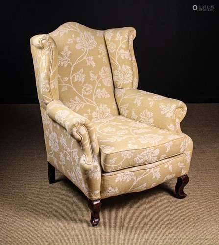 An Upholstered Wing Armchair.