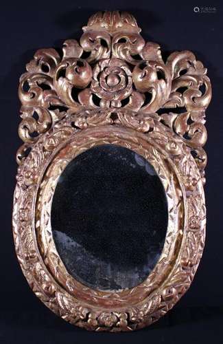 A 17th Century Baroque Style Carved Giltwood Mirror.