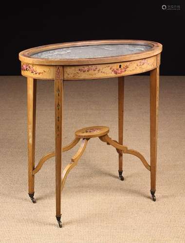 An Edwardian Bijouterie Table painted with swags of flowers.