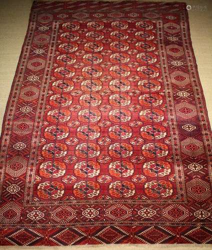 A Large Tekki Bokhara Claret Ground Rug with four rows of tw...