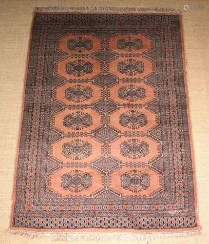 A Tekki Rug with six rows of two guls on a pink ground (A/F)...