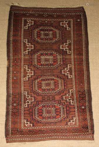 A Caucasian Brown Ground Rug woven with four medallions in a...