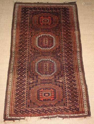 A Caucasian Brown Ground Rug woven with four octagonal medal...