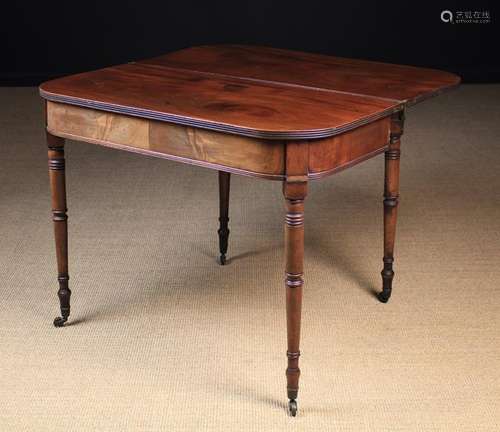 A George IV Mahogany Fold-over Tea Table standing on slender...