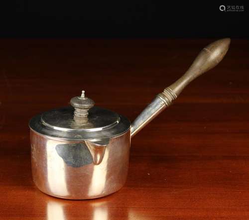 A William IV Silver Lidded Saucepan with hinged spout and si...