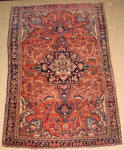 A Persian Wool Carpet woven in dark blue, mid blue,