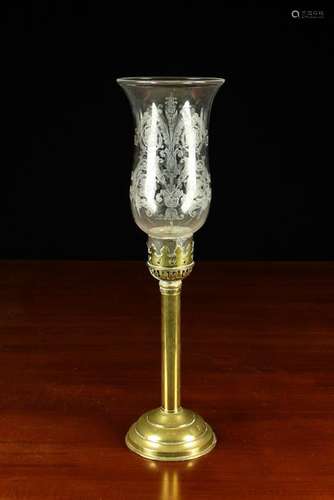 A Brass Candle Lamp with a decorative etched clear glass tul...