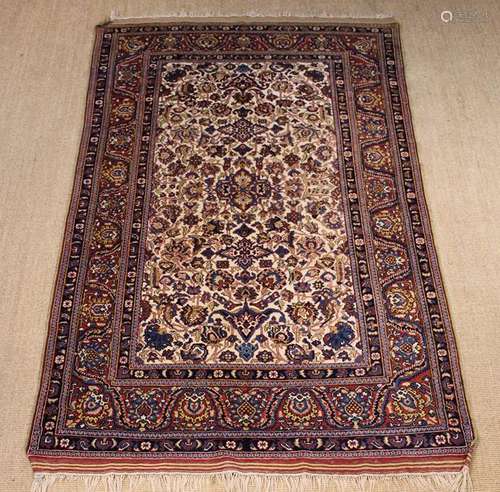 A Persian Rug woven with intricate floral motifs on an ivory...