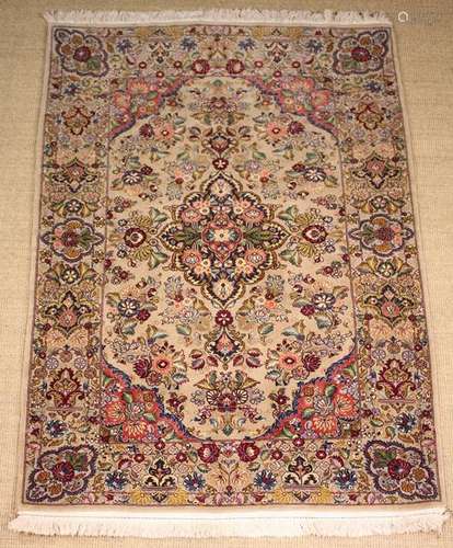 A Goum Carpet Rug woven with a Persian design with floral mo...