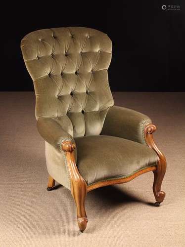 A Victorian Carved Mahogany Upholstered Armchair.