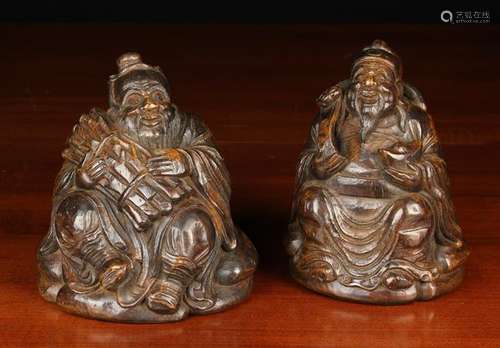 A Pair of Dark Patinated Bamboo Carvings of Seated Buddhisti...