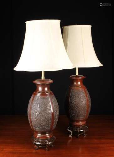 A Pair of Oriental Style Patinated Cast Metal Lamps with cre...