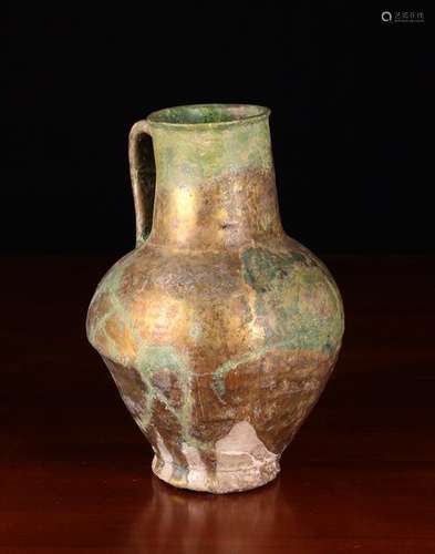 An Ancient Persian Ceramic Jug (A/F) with thick dripped irid...