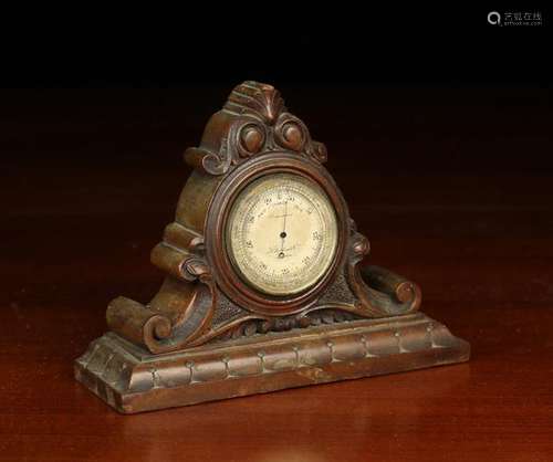 A 19th Century Pocket Barometer in a carved mahogany stand. ...