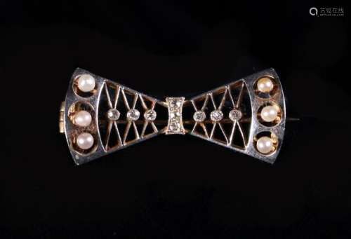 A 15 Carat Gold Bow Brooch adorned with diamond chips and se...