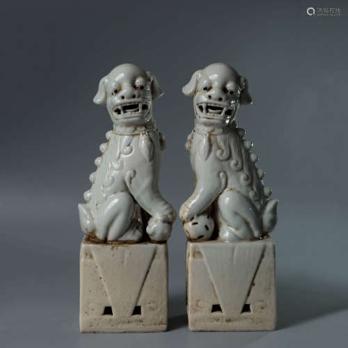 A Pair of White-Glazed Porcelain Lions