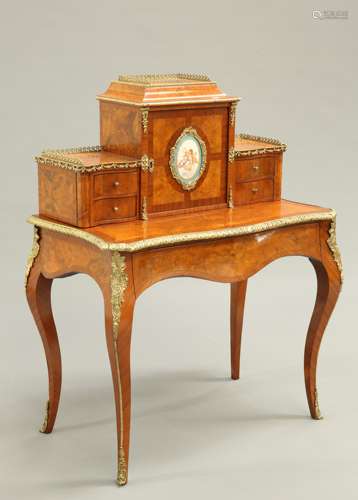 A FINE LOUIS XV STYLE GILT-METAL AND PORCELAIN MOUNTED WALNU...