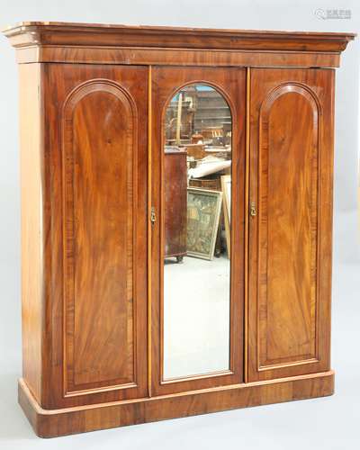 A MID VICTORIAN MAHOGANY THREE-DOOR WARDROBE