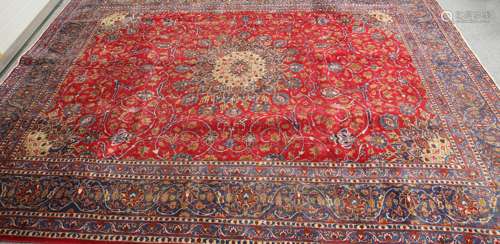 A PERSIAN RED GROUND KASHAN CARPET