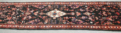 A LARGE PERSIAN SAROUK RUNNER