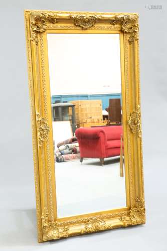 A LARGE PERIOD STYLE GILT-COMPOSITION MIRROR