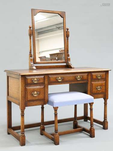 A PERIOD STYLE OAK DRESSING TABLE AND FOOTSTOOL BY TITCHMARS...