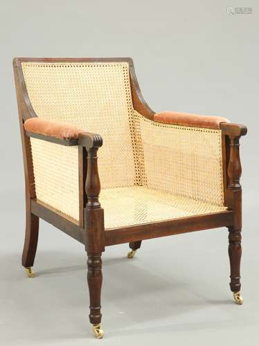 A LATE GEORGE III MAHOGANY BERGERE CHAIR