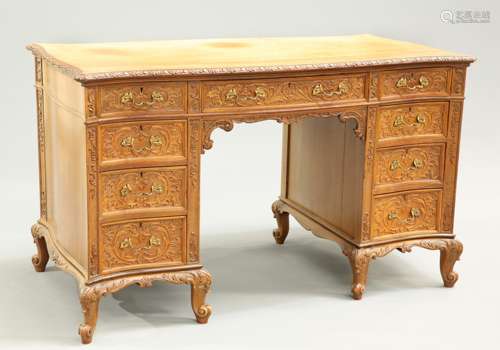 AN EARLY 20TH CENTURY CARVED WALNUT DESK