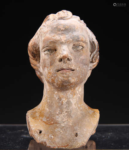 A TERRACOTTA HEAD OF A MAN